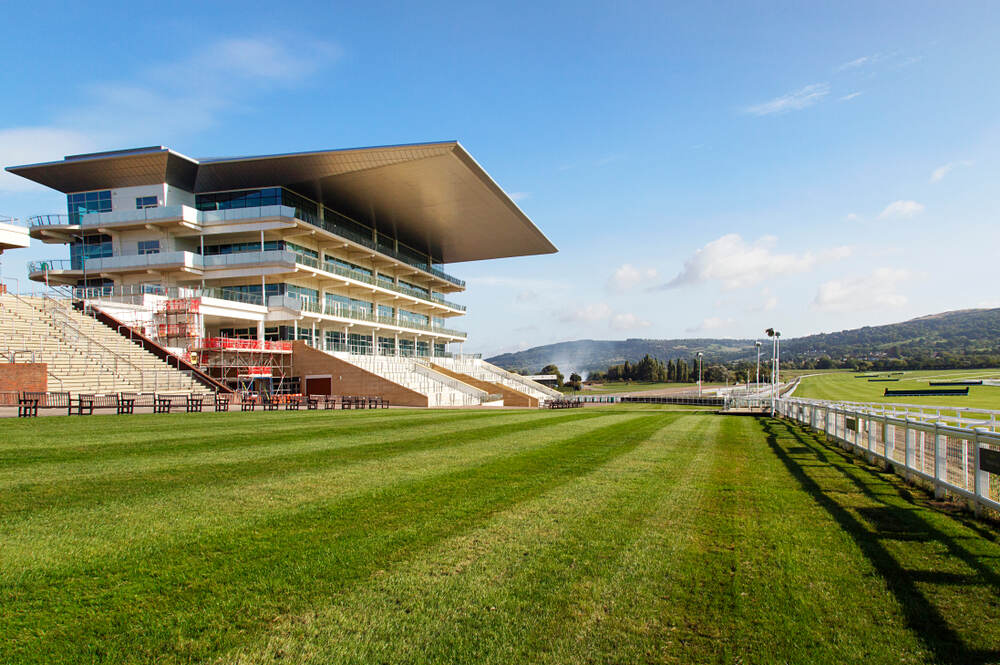 Cheltenham Racecourse during the Festival, with crowds and the grandstand in view