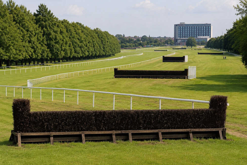 Steeplechase fences and white rails on the jumps track at Doncaster Racecourse